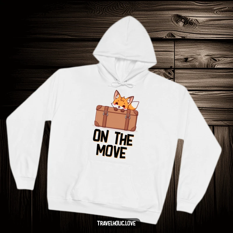 Funny fox peeking from behind a giant cartoon suitcase on a cozy hoodie, perfect for travel.