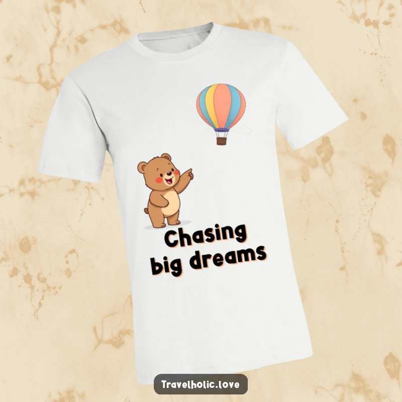 Funny bear cub excitedly pointing at a distant colorful hot air balloon, a humorous and inspiring t-shirt print.